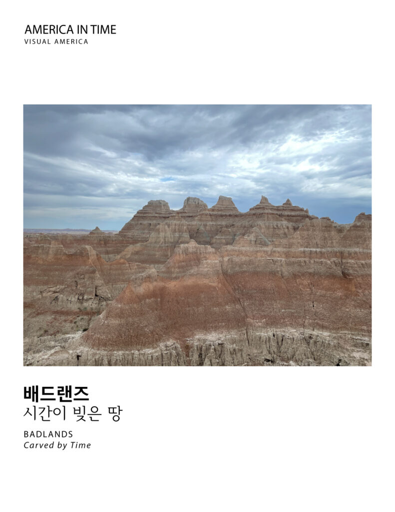 Eroded rock formations beneath dramatic clouds in the Badlands of South Dakota.