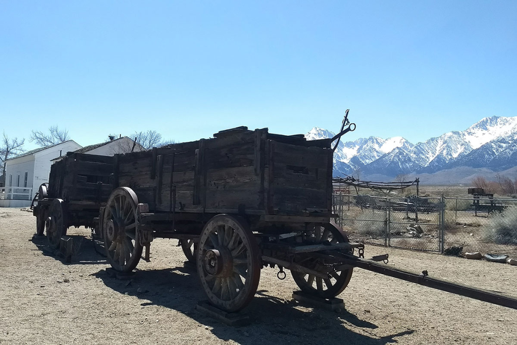 Historic wooden wagon with the Eastern Sierra Nevada mountains in the background